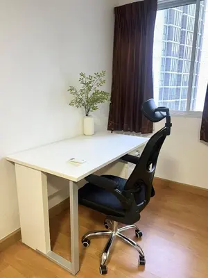a white desk with a black chair in an office at Breezy 1BR Near BTS Udomsuk in Amphoe Phra Khanong