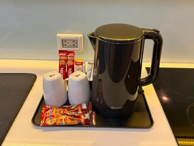 a coffee pot sitting on a stove with some food at 5 Min walk to BTS Onnut Duplex Loft At Sukhumvit in Amphoe Phra Khanong