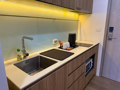 a kitchen with a sink and a counter top at 5 Min walk to BTS Onnut Duplex Loft At Sukhumvit in Amphoe Phra Khanong
