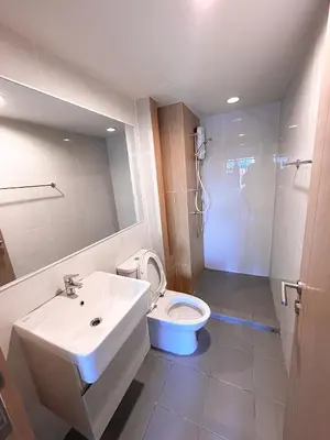 a bathroom with a sink and a toilet and a shower at Luxury apartment near On Nut BTS station with swimming pool in Amphoe Phra Khanong