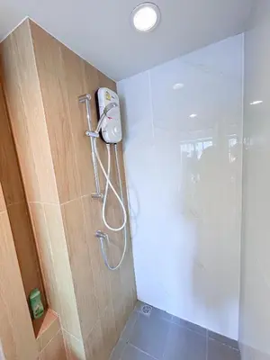a shower in a bathroom with a glass shower stall at Luxury apartment near On Nut BTS station with swimming pool in Amphoe Phra Khanong