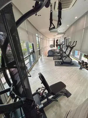 a gym with several treadmills and exercise bikes at Luxury apartment near On Nut BTS station with swimming pool in Amphoe Phra Khanong