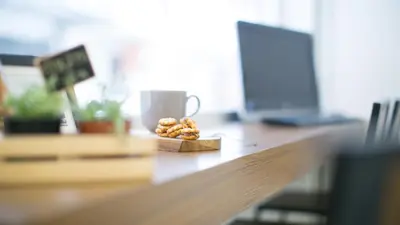 a pile of donuts on a table with a coffee cup at Lamurr Sukhumvit 41 in Bangkok