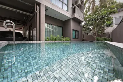a swimming pool in front of a building at Like Sukhumvit 22 in Bangkok