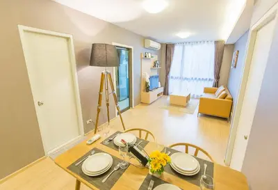 a dining room with a table and a living room at Like Sukhumvit 22 in Bangkok