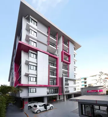 a building with two cars parked in front of it at Praso@Ratchada12 in Bangkok