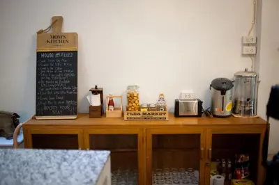 a wooden table with a menu on top of it at Victory Park Hostel in Bangkok