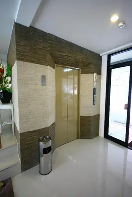 a hallway with a gold door in a room at At Home Phetkasem in Bangkok