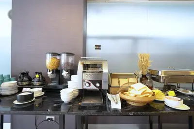 a kitchen with a counter with a mixer and food at Cubic Pratunam in Bangkok