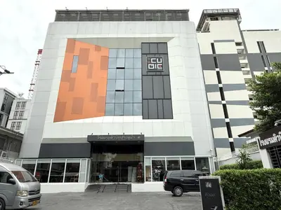 a building with a large building with a store at Cubic Pratunam in Bangkok