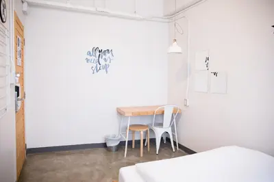 a small room with a table and two chairs at Movylodge in Bangkok