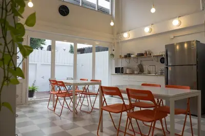 a kitchen with a table and chairs and a refrigerator at Movylodge in Bangkok