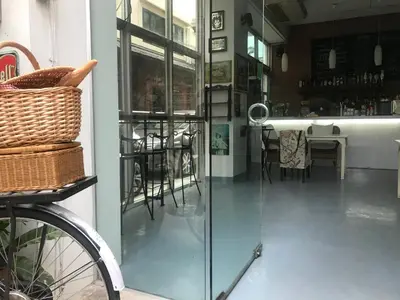 a bike parked next to a room with a table at Oriental Smile Hotel in Bangkok