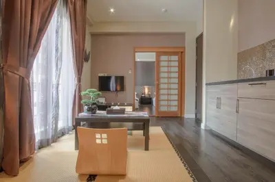 a living room with a table and a couch at The Star of Sathorn in Bangkok