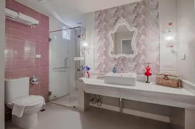 a bathroom with a sink and a toilet and a mirror at The Star of Sathorn in Bangkok