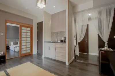 a living room with a kitchen and a bedroom at The Star of Sathorn in Bangkok