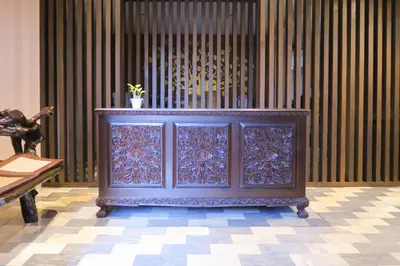 a blue cabinet with a potted plant on top of it at The Grand Palace Hotel in Bangkok