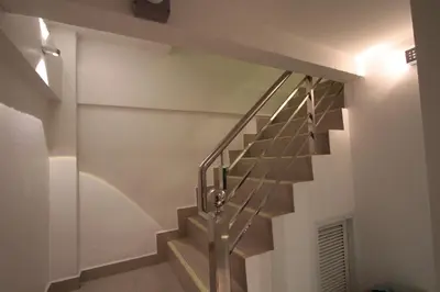 a staircase in a building with a metal railing at Napaville Huai Khwang in Bangkok