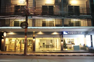 a nappyville store on a city street at night at Napaville Huai Khwang in Bangkok