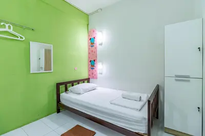 a hospital room with a bed and a shower at Sleep Dee Hostel in Bangkok