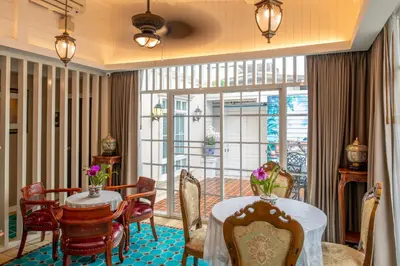 a dining room with a table and chairs and a window at The Orchid House 153 in Bangkok