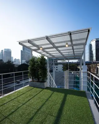 a balcony with awning on top of a building at On the Bed Hostel in Bangkok
