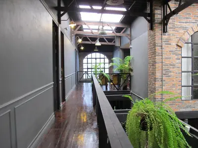 a hallway in a building with a brick wall at J No.14 in Bangkok