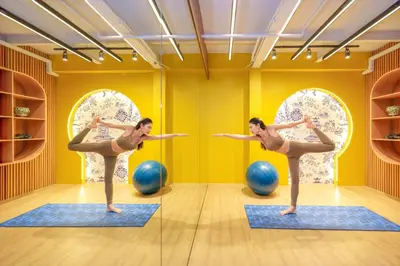 two women doing yoga in a gym with blue pilates balls at Metropole, Bangkok, a Tribute Portfolio Hotel by Marriott in Bangkok