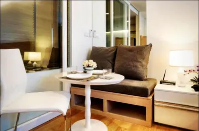 a living room with a table and a couch at Luxury Suite @ BTS Nana in Bangkok