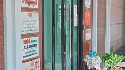 a door of a building with a sign on it at Collection O The Bangkok Cha Cha Suite in Bangkok
