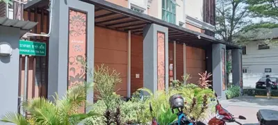 a motorcycle parked in front of a building at Collection O The Bangkok Cha Cha Suite in Bangkok