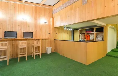 a large room with wooden walls and a counter with chairs at Double Five in Bangkok
