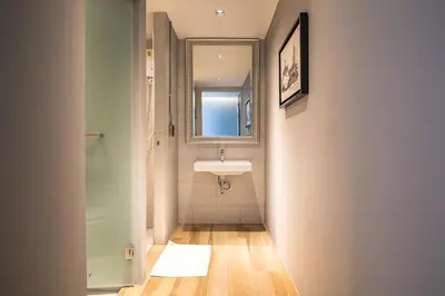 a bathroom with a sink and a window at Sleep Box Hotel Sukhumvit 22 in Bangkok