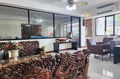 a living room with a wood carving of a dragon at Kim Hotel At Bangplong in Bangkok