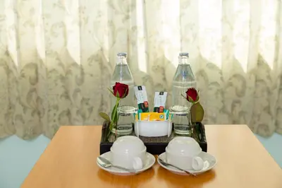 a tray with two bottles and two cups and dishes on a table at The Garden Place Bangkok in Nonthaburi