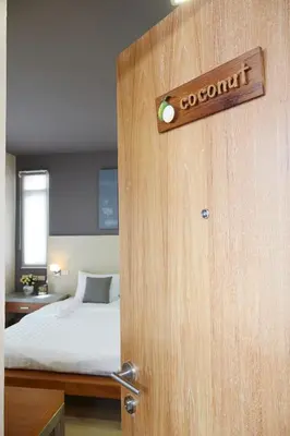 a wooden door with a sign that reads covenant at Uncle Loy's Boutique House in Bangkok