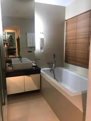 a bathroom with a white tub and a sink at Paradiso Boutique Suites in Bangkok