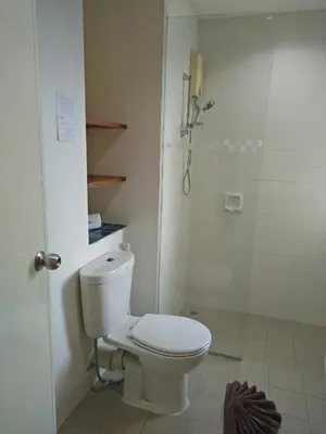 a bathroom with a toilet and a shower at JL Bangkok Hotel in Bangkok