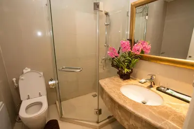 a bathroom with a toilet and a sink and a shower at Hope Land Hotel 46/1 in Bangkok