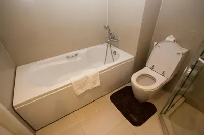 a bathroom with a toilet and a bath tub with a sink at Hope Land Hotel 46/1 in Bangkok
