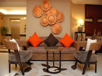 a living room with a couch and two chairs at De Arni Bangkok - SHA Extra Plus in Bangkok