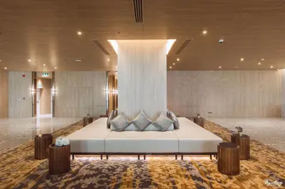 a room with a bed with pillows on it at Grand Richmond Stylish Convention Hotel in Nonthaburi