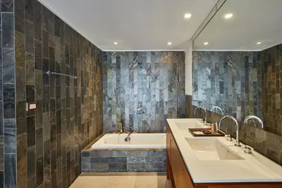 a bathroom with two sinks and a tub at LUXX Langsuan Hotel - SHA Plus in Bangkok