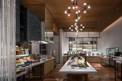 a large kitchen with a table with food on it at Somerset Sukhumvit Thonglor Bangkok in Bangkok