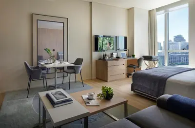a hotel room with a bed and a living room at Somerset Sukhumvit Thonglor Bangkok in Bangkok