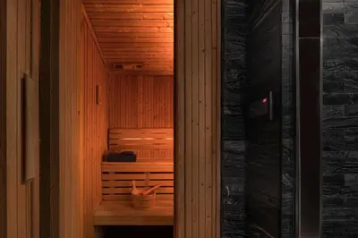 a sauna with a wooden wall and a wooden floor at Somerset Sukhumvit Thonglor Bangkok in Bangkok