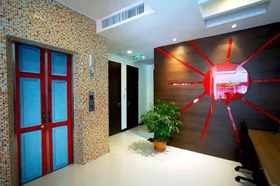 a large clock on the wall in a room at Ds67 Suites in Bangkok