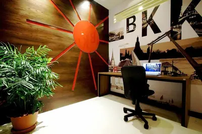 an office with a desk and a clock on the wall at Ds67 Suites in Bangkok