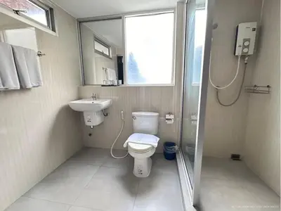 a bathroom with a toilet and a sink and a shower at Collection O The Step Sathorn in Bangkok