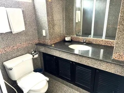a bathroom with a toilet and a sink at Collection O The Step Sathorn in Bangkok